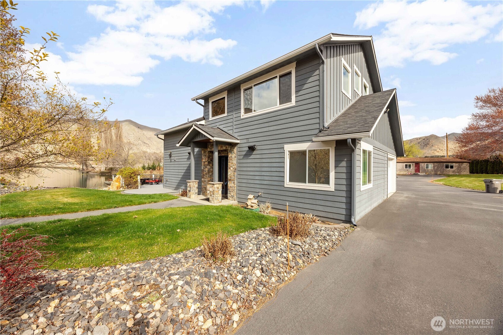 2 Playland Court Orondo, WA 98843 - Photo 33 of 40 a front view of a house with a yard and garage