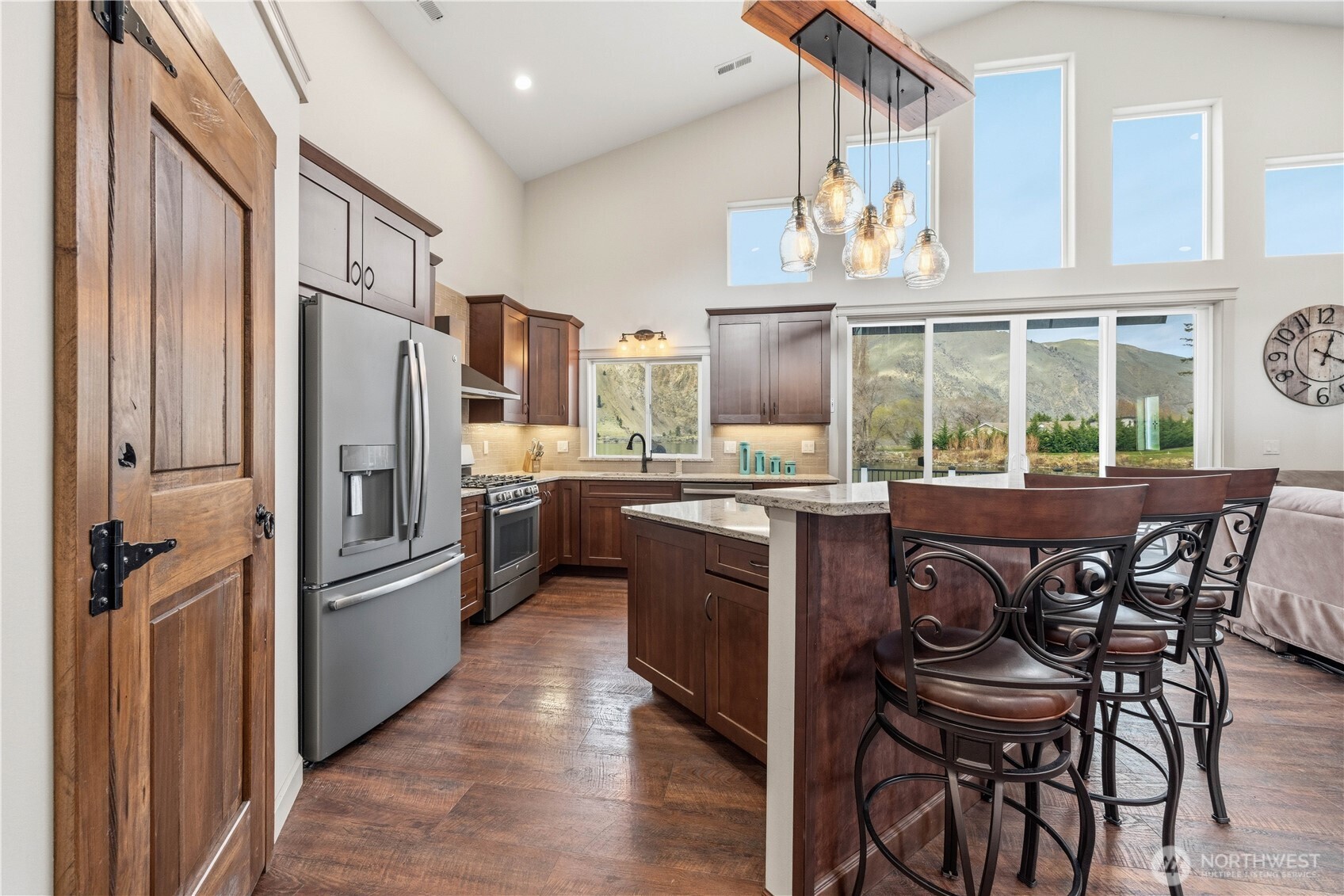 2 Playland Court Orondo, WA 98843 - Photo 5 of 40 a kitchen with a refrigerator a stove and a dining table with wooden floor