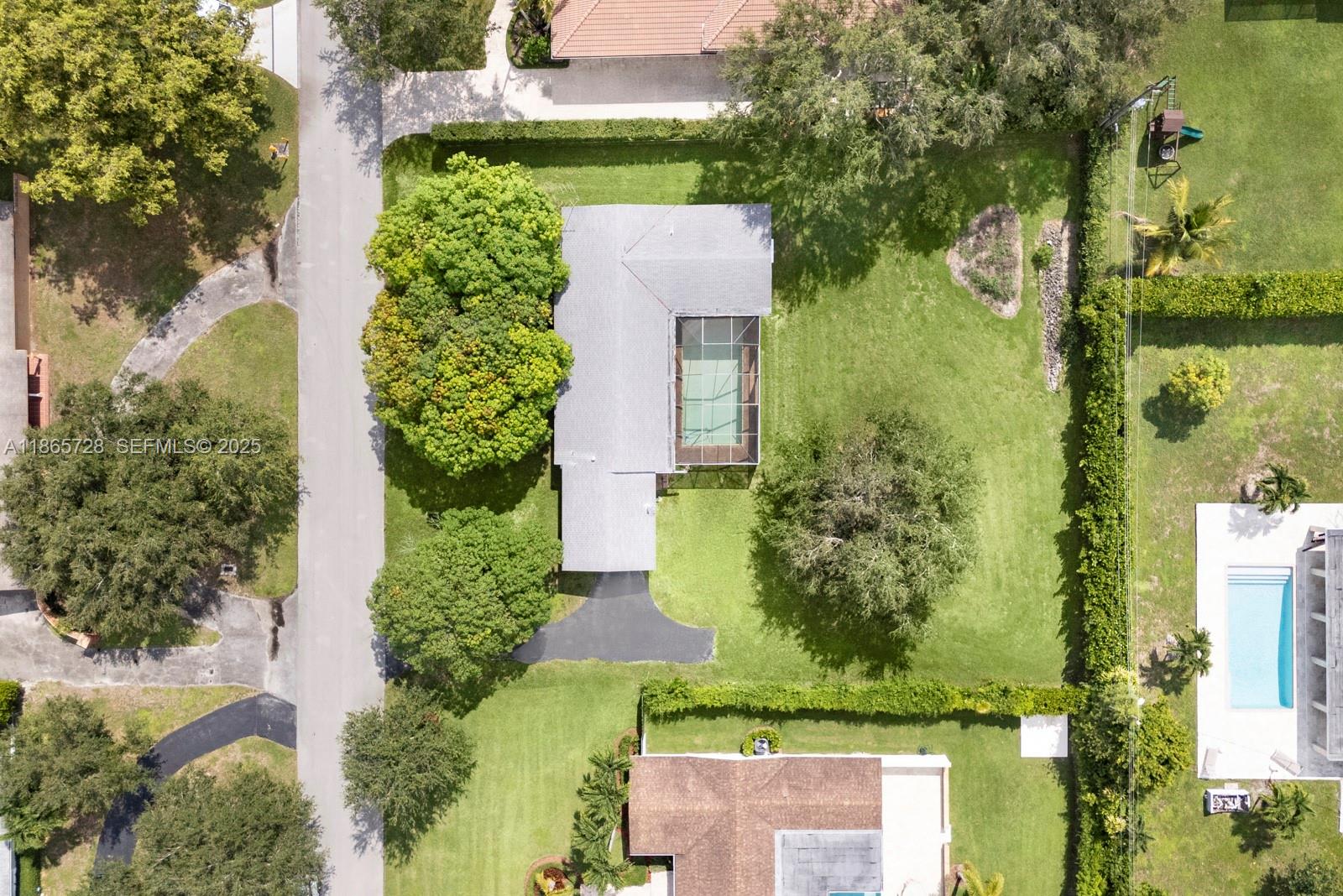 7320 Southwest 131st Street Pinecrest, FL 33156 - Photo 1 of 8 an aerial view of a house with a yard and lake view