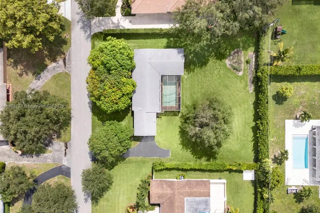 an aerial view of a house with a yard and lake view