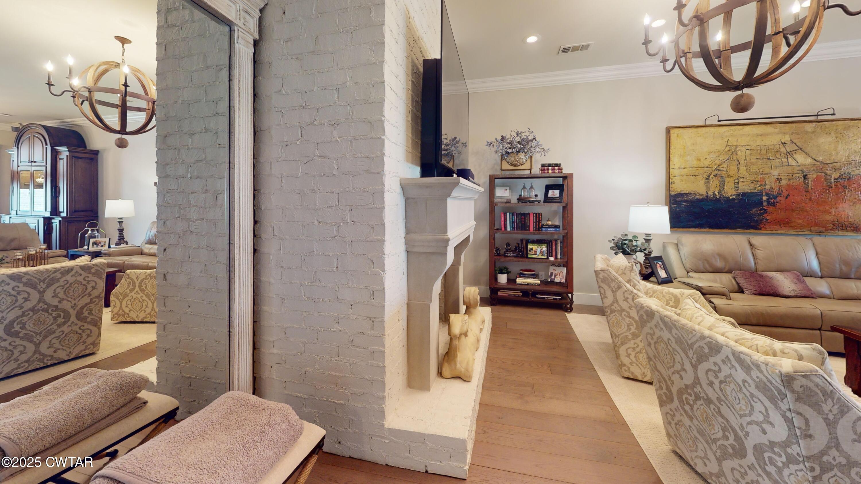 79 Water Ridge Place Jackson, TN 38305 - Photo 14 of 39 a living room with furniture a flat screen tv and a floor to ceiling window