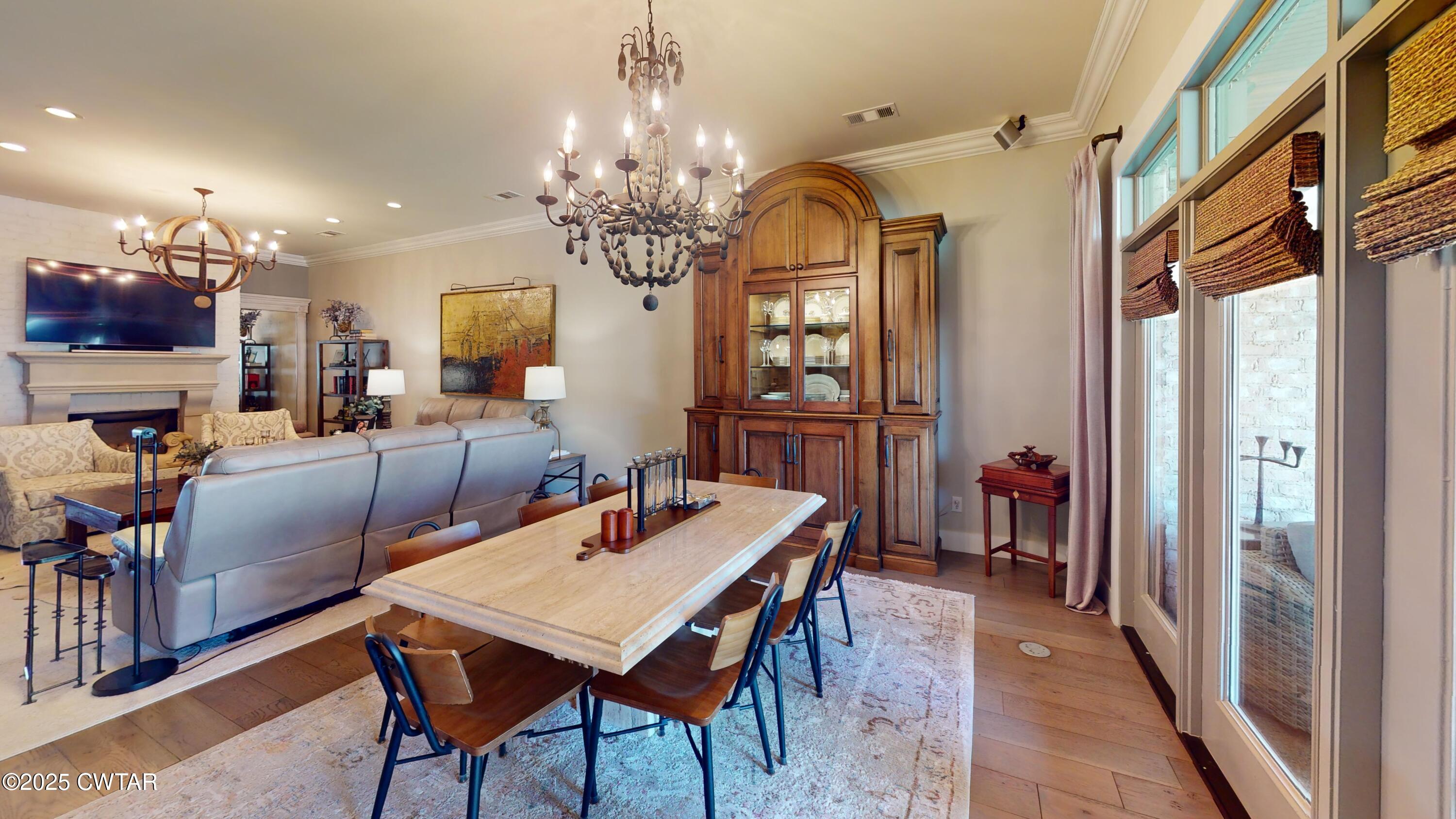 79 Water Ridge Place Jackson, TN 38305 - Photo 16 of 39 a view of a dining room with furniture a chandelier and wooden floor