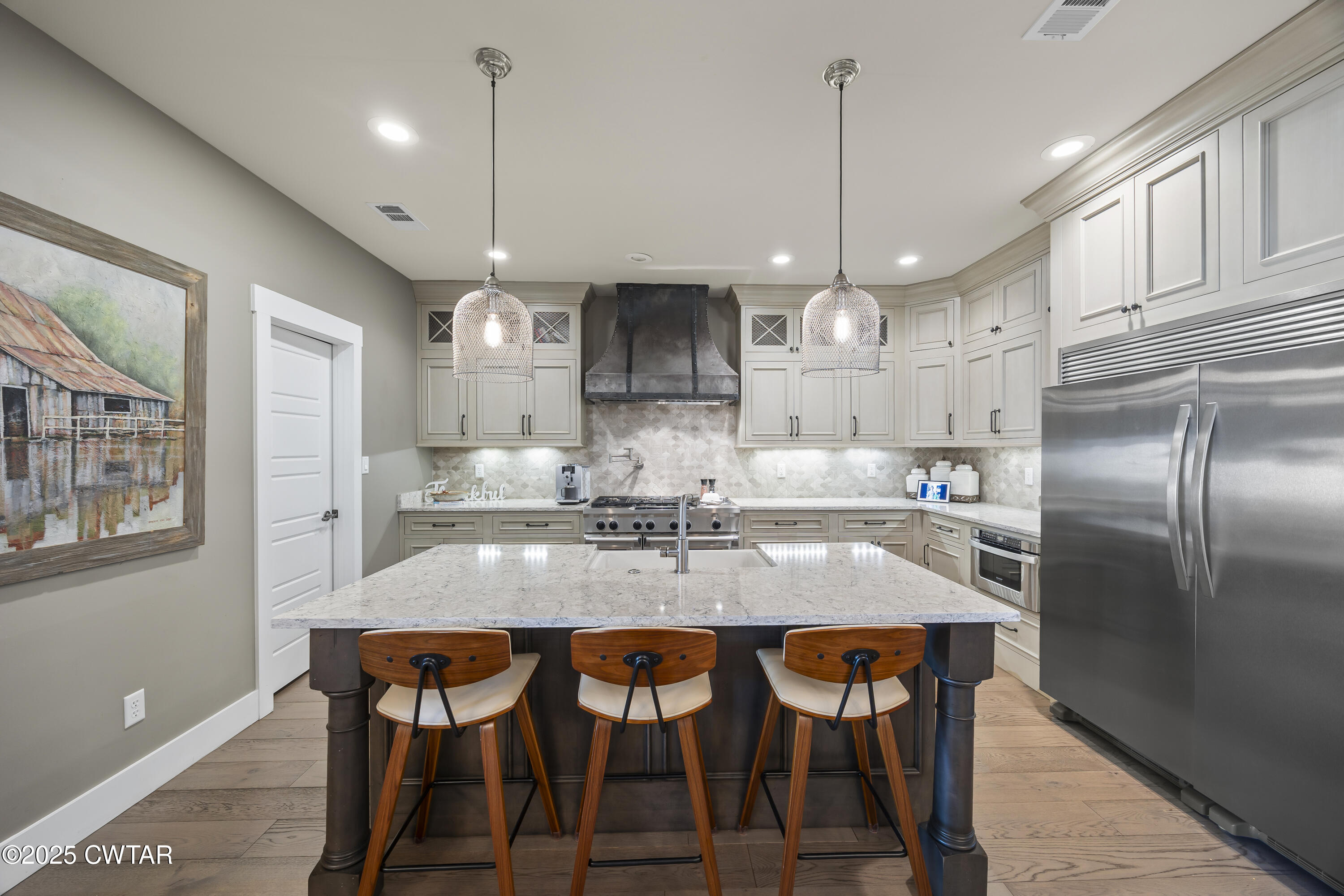 79 Water Ridge Place Jackson, TN 38305 - Photo 17 of 39 a kitchen with granite countertop a kitchen island white cabinetry and refrigerator