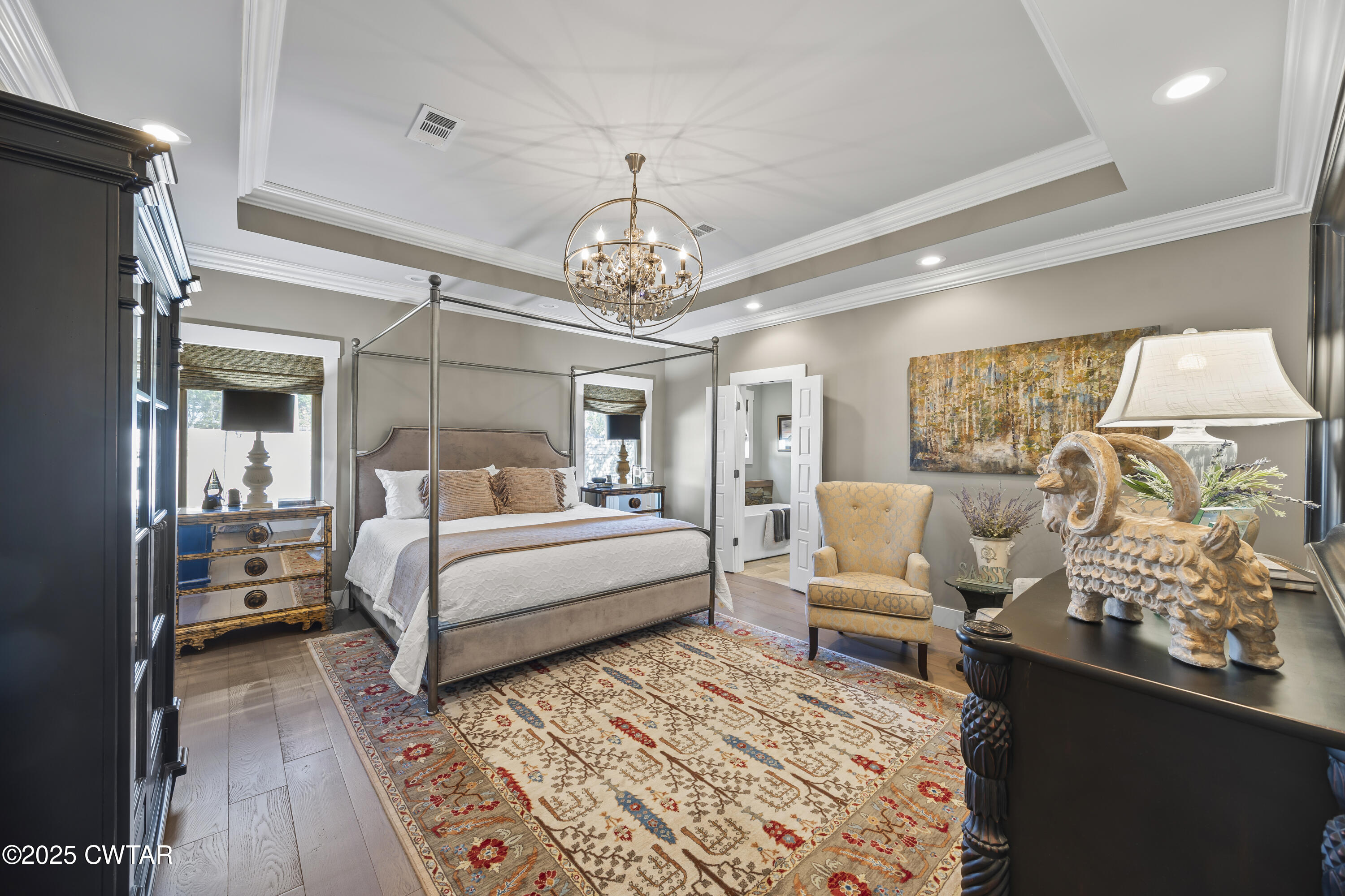 79 Water Ridge Place Jackson, TN 38305 - Photo 20 of 39 a bedroom with a large bed and a chandelier