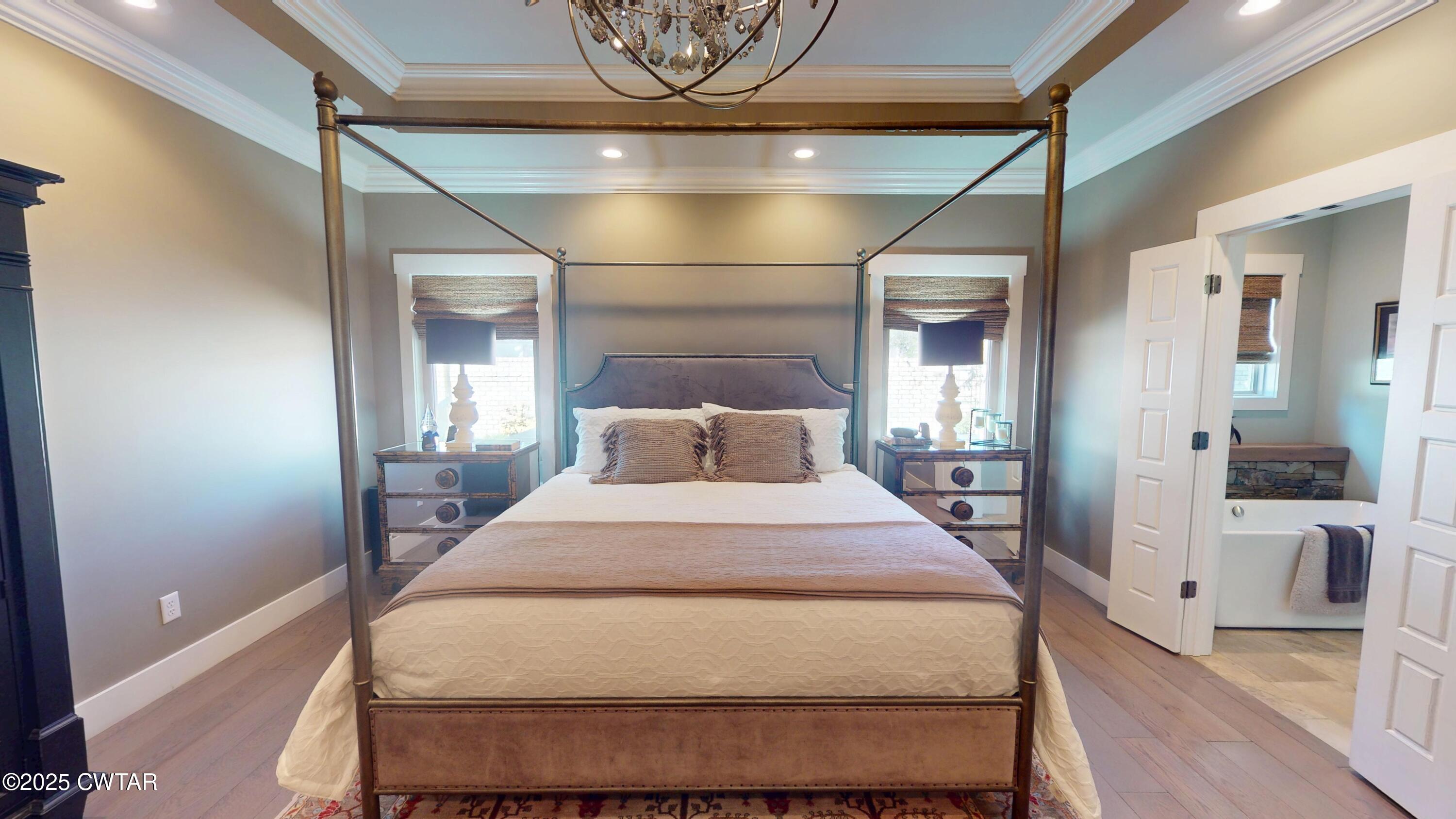 79 Water Ridge Place Jackson, TN 38305 - Photo 22 of 39 a bedroom with a bed and wooden floor