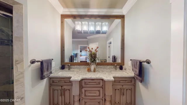a bathroom with a granite countertop toilet a sink and a mirror