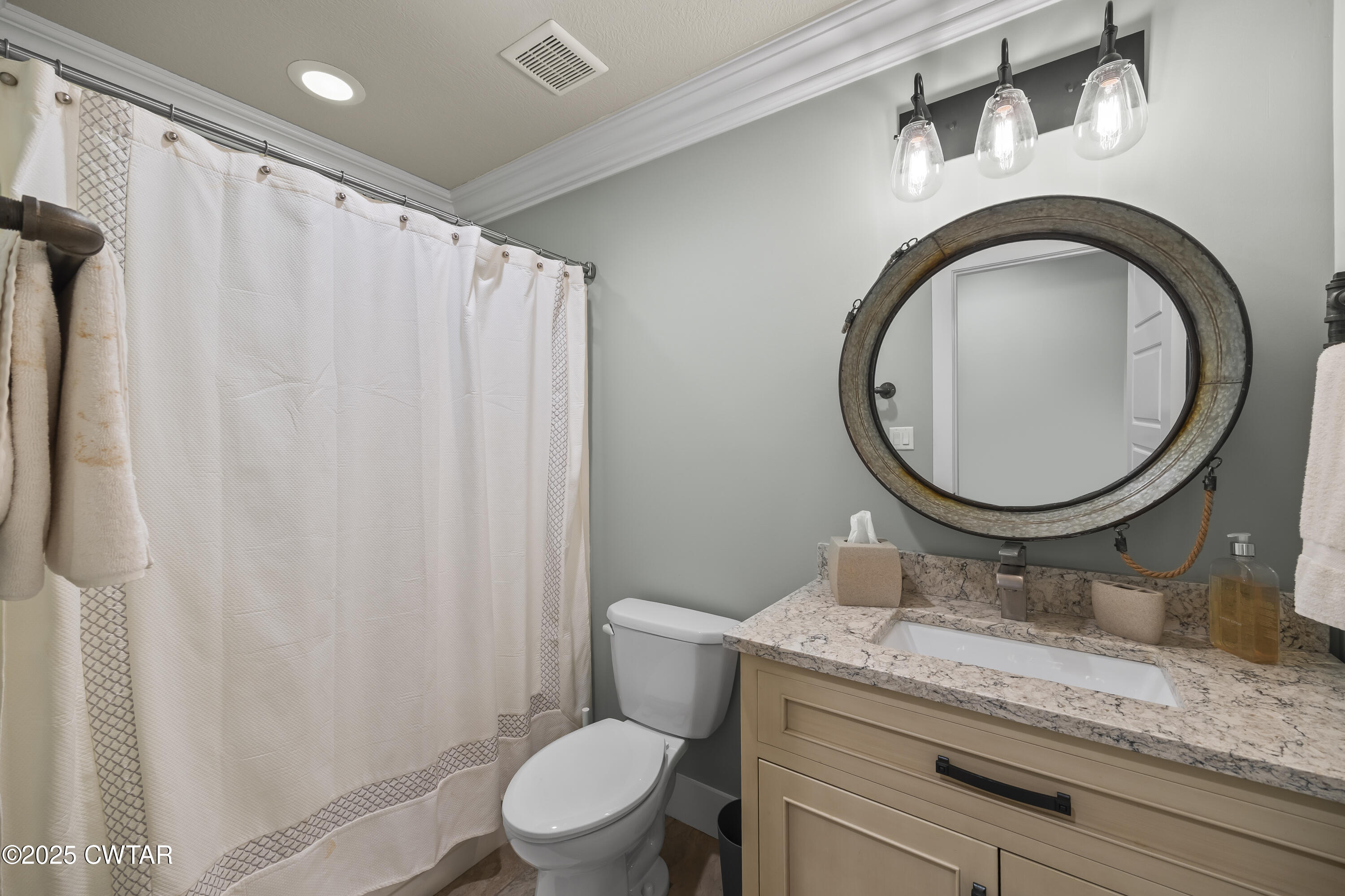 79 Water Ridge Place Jackson, TN 38305 - Photo 36 of 39 a bathroom with a granite countertop toilet a sink and a mirror