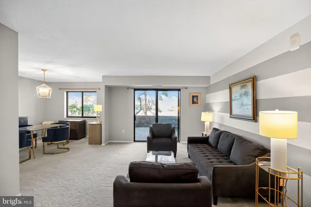 a living room with furniture a lamp and a window