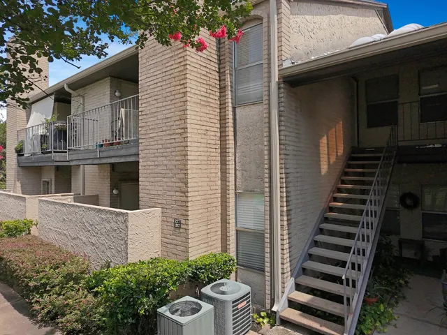a front view of a house with plants