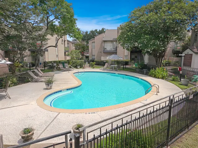 a view of a swimming pool with a patio