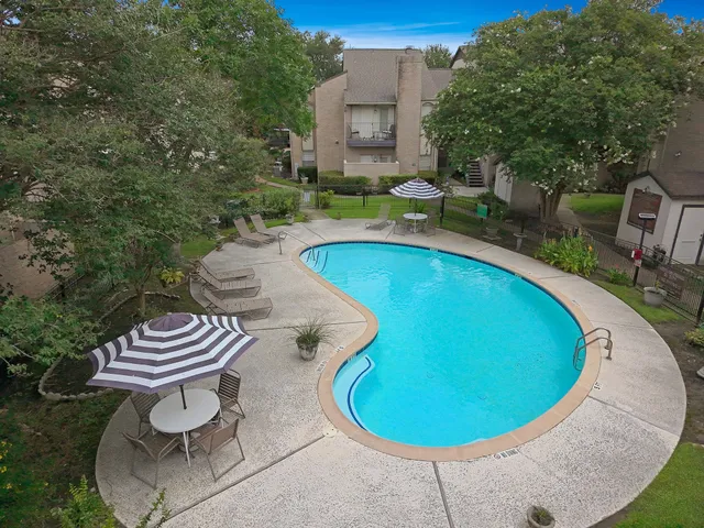 a view of a swimming pool with a outdoor seating