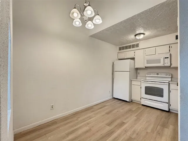 a view of a kitchen with a dishwasher a kitchen view and a stove