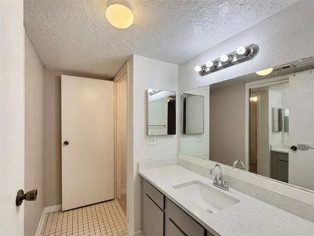 a bathroom with a sink a light fixture and a mirror