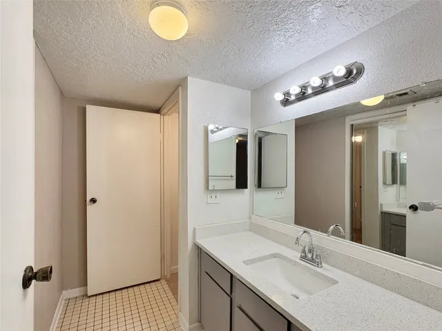a bathroom with a sink a light fixture and a mirror