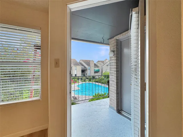 a view of a glass door and a yard from a window