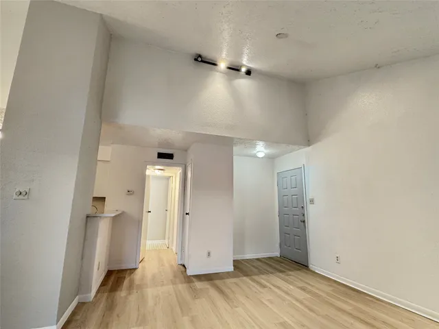 an empty room with wooden floor and a window