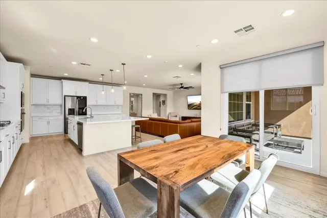 a open kitchen with white cabinets and stainless steel appliances