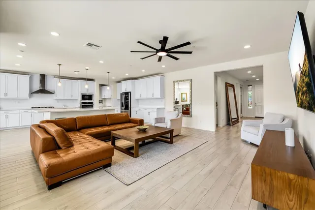 a living room with furniture and a wooden floor