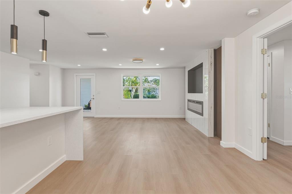 1330 Horizon Road Venice, FL 34293 - Photo 19 of 40 a view of an empty room with a window and wooden floor