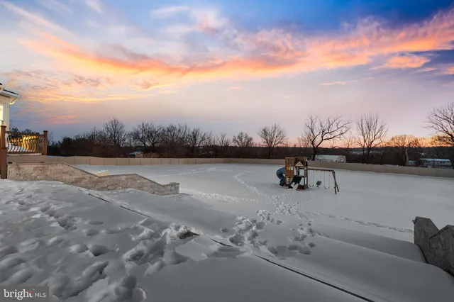 a kitchen with stainless steel appliances kitchen island granite countertop a stove and a refrigerator