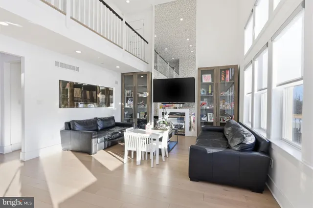a bedroom with a bed and a flat tv screen on dresser