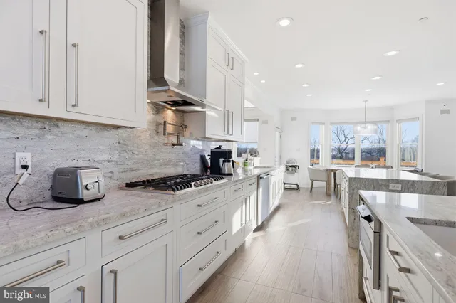 a kitchen with stainless steel appliances granite countertop sink refrigerator and microwave