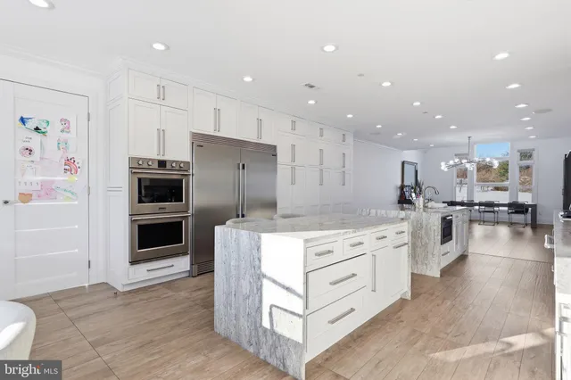 a kitchen with stainless steel appliances granite countertop a stove and a sink
