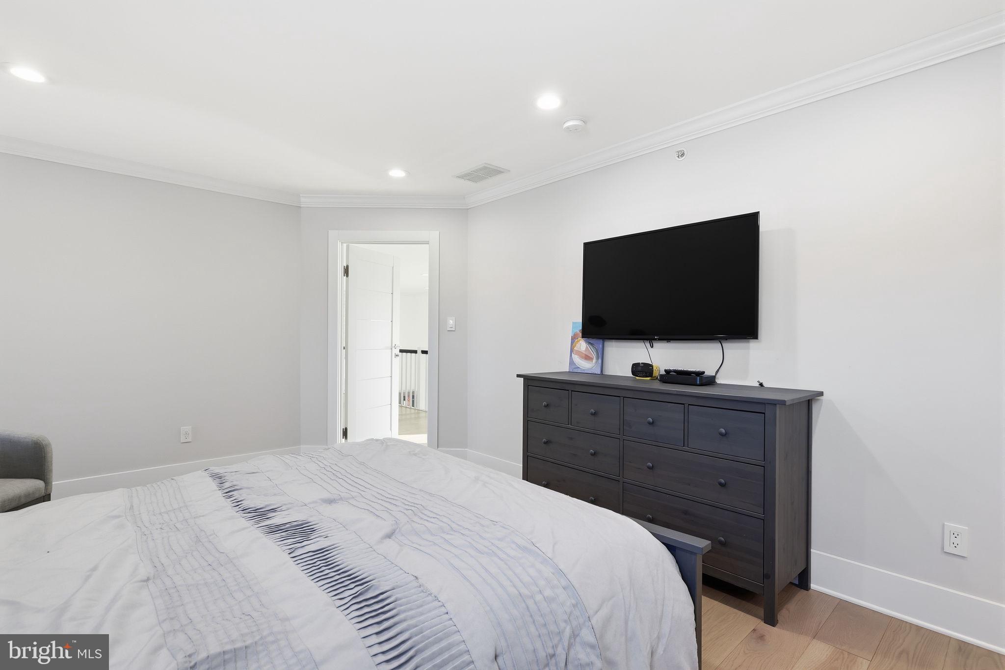 2145 Second Street Pike Newtown, PA 18940 - Photo 52 of 79 a bedroom with a bed and a flat tv screen on dresser