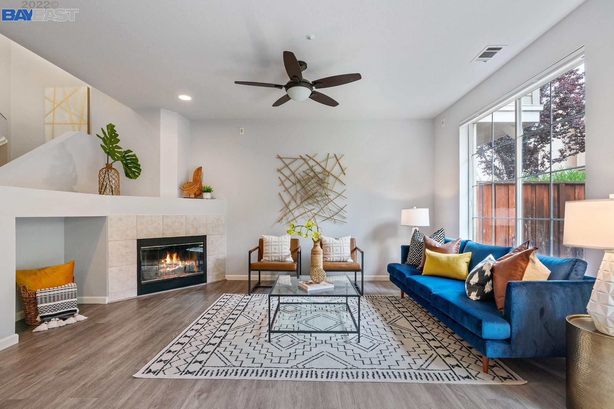 a living room with furniture fireplace and window
