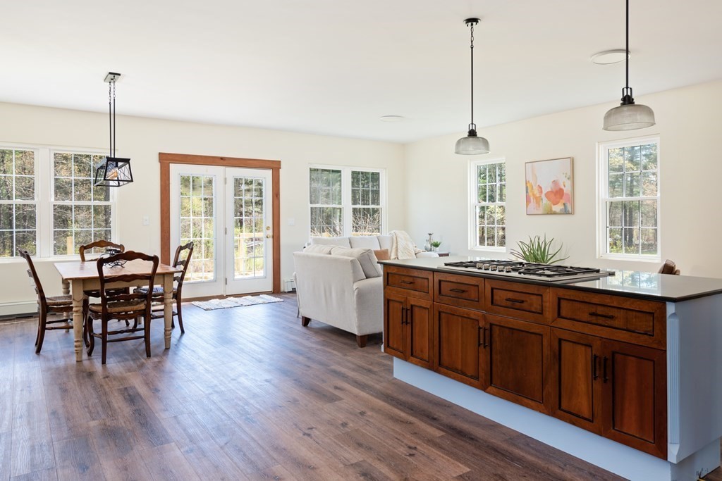 249 Blackmore Pond Road Wareham, MA 02576 - Photo 14 of 41 a open kitchen with stainless steel appliances granite countertop wooden floors and white cabinets