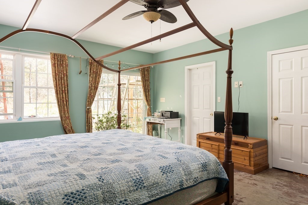 249 Blackmore Pond Road Wareham, MA 02576 - Photo 27 of 41 a bedroom with a bed wooden floor and a large window