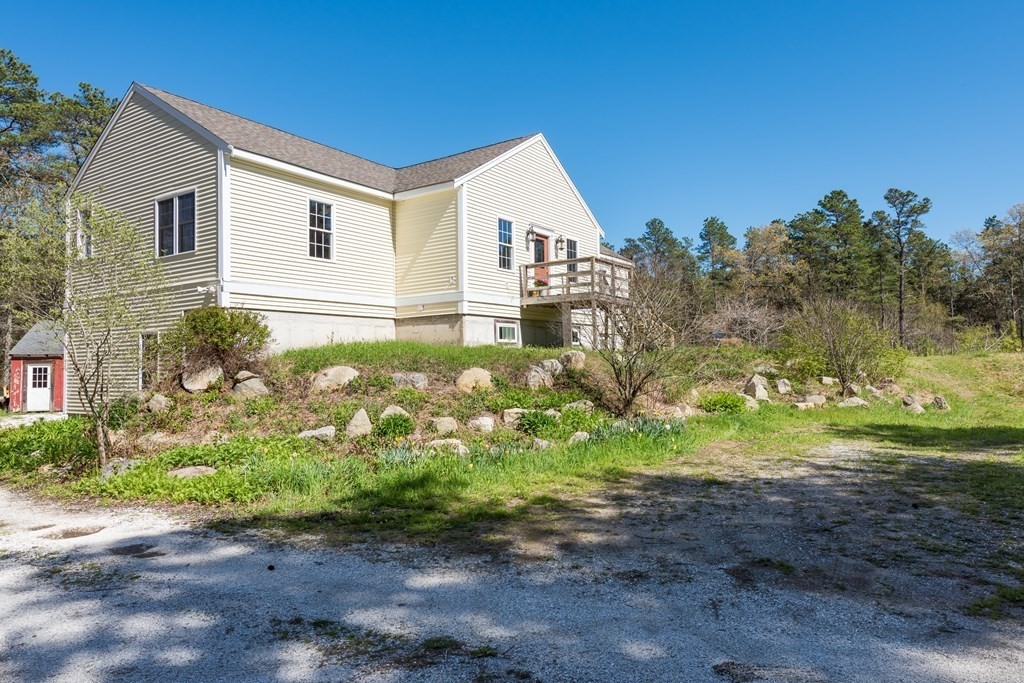 249 Blackmore Pond Road Wareham, MA 02576 - Photo 30 of 41 a view of a yard in front of a house with a yard