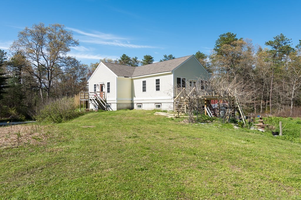 249 Blackmore Pond Road Wareham, MA 02576 - Photo 5 of 41 a view of a house with a back yard