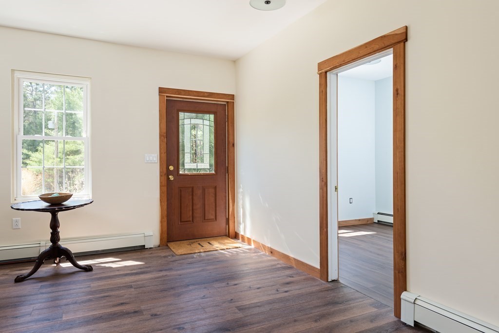 249 Blackmore Pond Road Wareham, MA 02576 - Photo 9 of 41 a view of a room with wooden floor staircase and windows