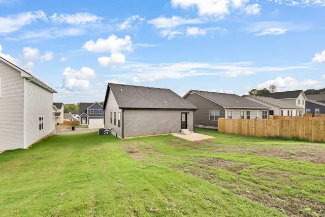 a view of a house with a yard and garage