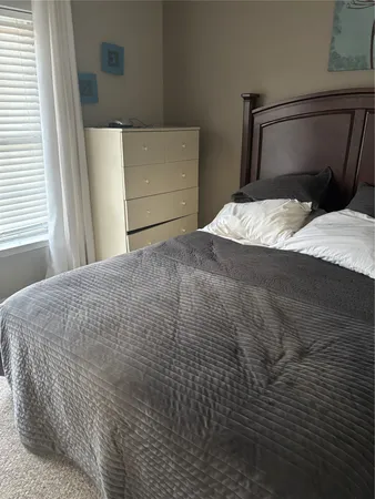 a bedroom with a bed and a mirror