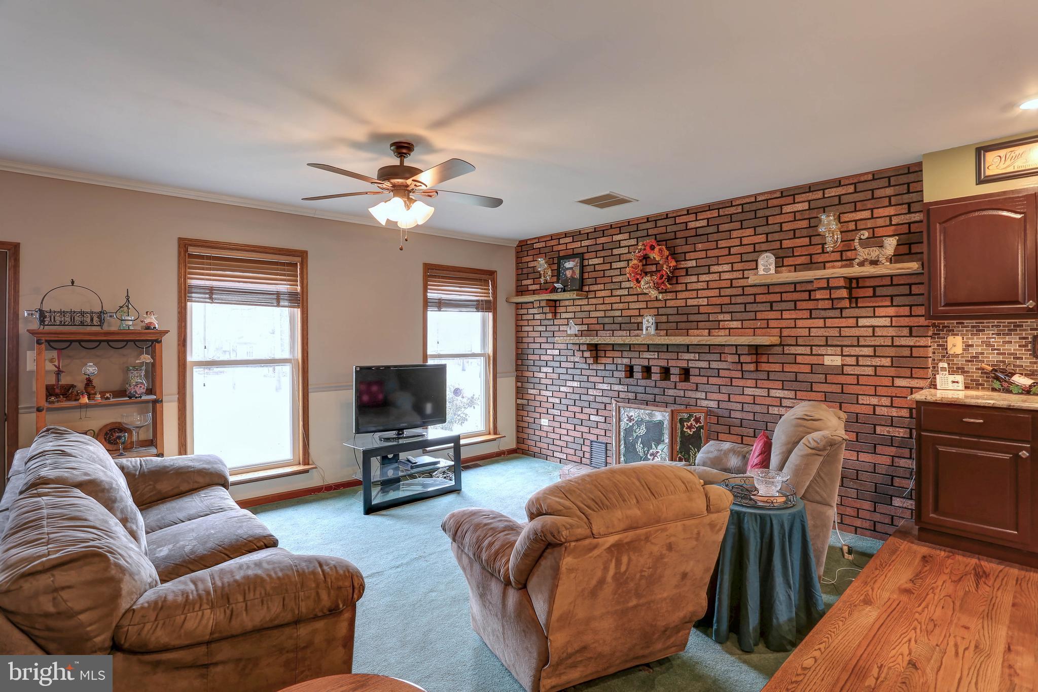 8474 Leishear Road Laurel, MD 20723 - Photo 3 of 61 Living room with gas log fireplace - ceiling fan