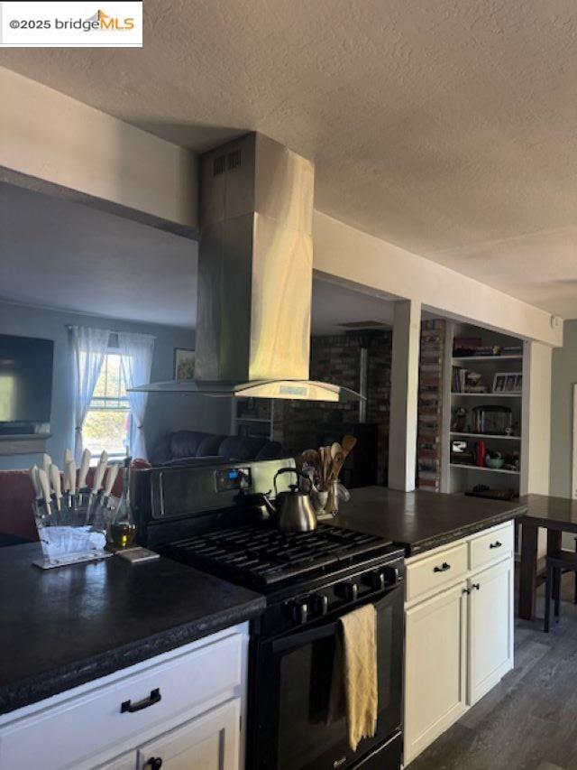 21890 Phoenix Lake Road Sonora, CA 95370 - Photo 14 of 22 Kitchen featuring island exhaust hood, black gas range, white cabinets, a textured ceiling, and dark wood-type flooring