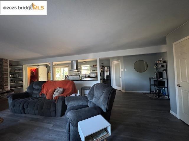 21890 Phoenix Lake Road Sonora, CA 95370 - Photo 16 of 22 Living room featuring dark wood finished floors and a barn door