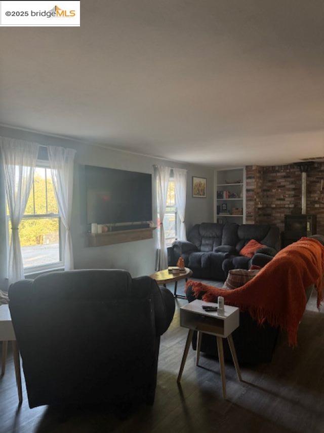 21890 Phoenix Lake Road Sonora, CA 95370 - Photo 17 of 22 Living room with a wood stove, wood finished floors, and built in features