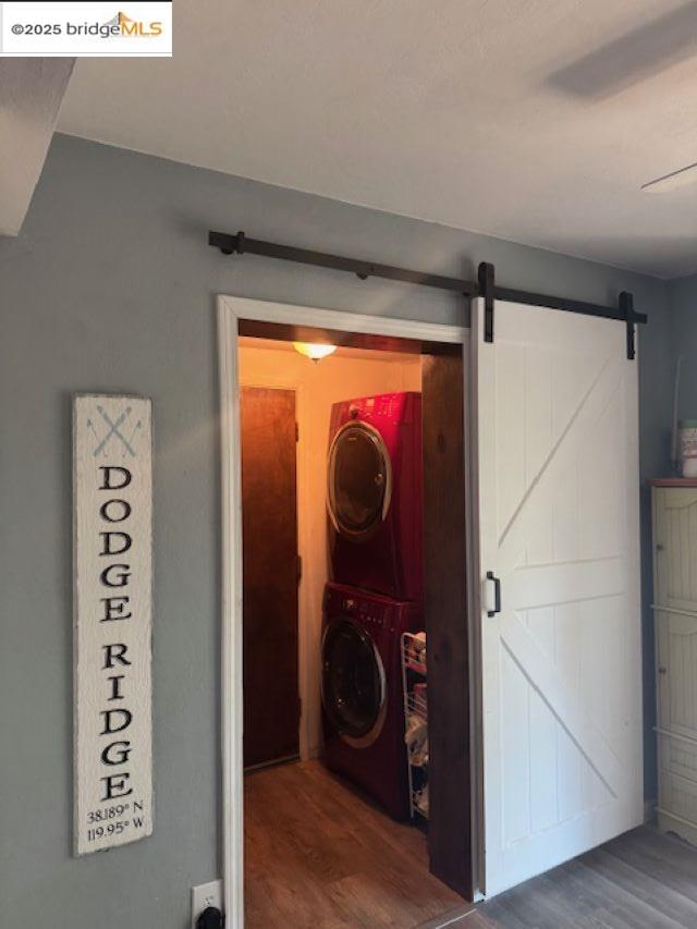 21890 Phoenix Lake Road Sonora, CA 95370 - Photo 18 of 22 Laundry room with dark wood-style floors and estacked washer and dryer