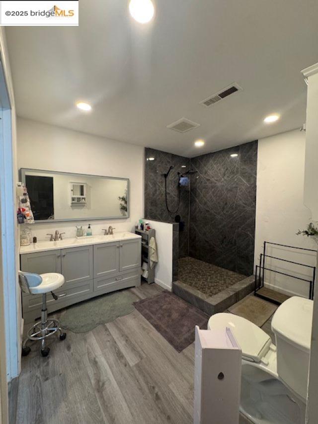 21890 Phoenix Lake Road Sonora, CA 95370 - Photo 4 of 22 Bathroom featuring a marble finish shower, double vanity, light wood finished floors, and recessed lighting