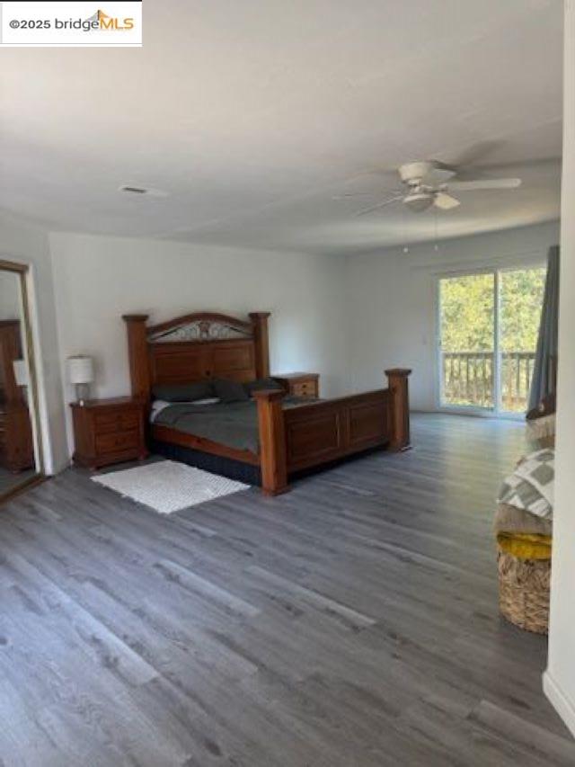 21890 Phoenix Lake Road Sonora, CA 95370 - Photo 6 of 22 Bedroom with dark wood-style floors, access to exterior, and a ceiling fan