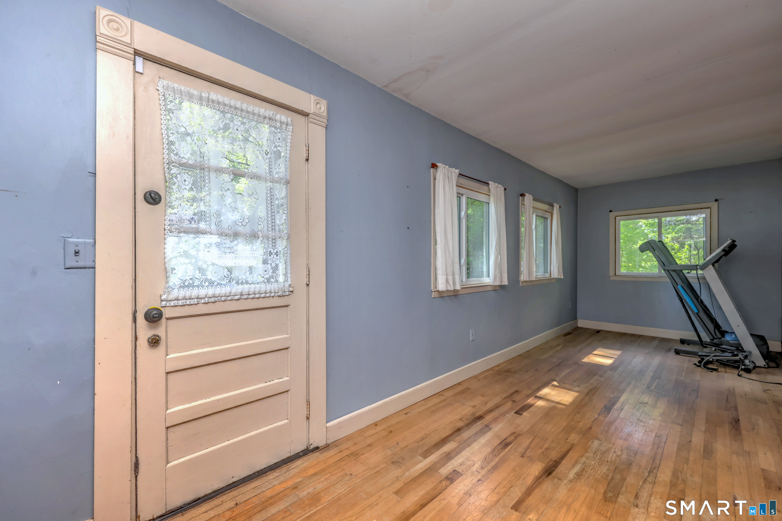 186 Jones Hill Road West Haven, CT 06516 - Photo 5 of 33 a view of a room with gym equipment and a window