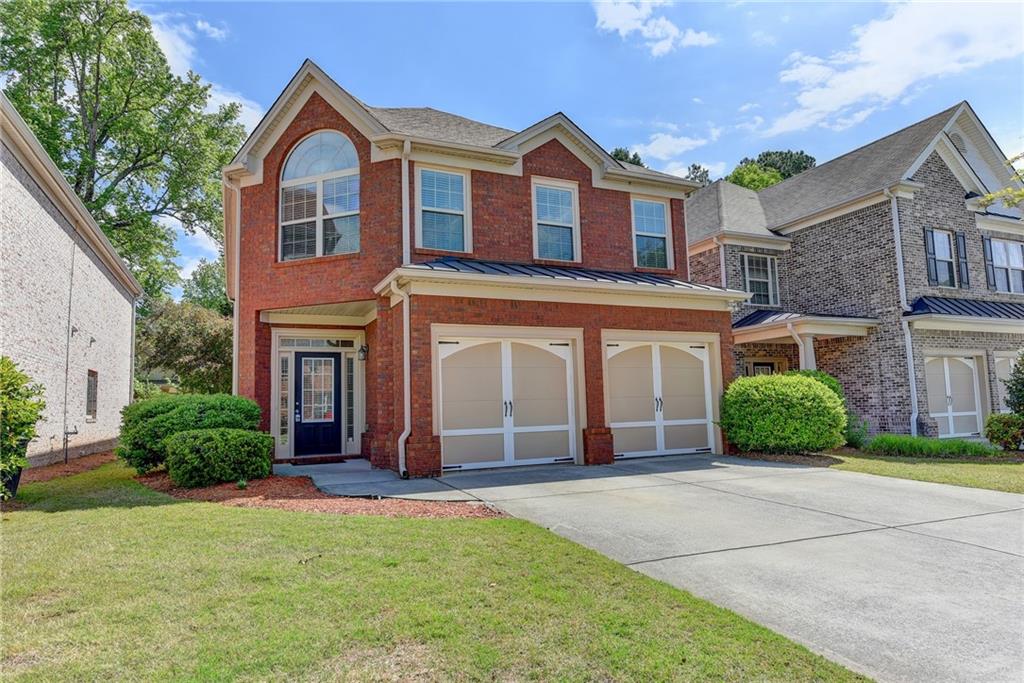 2253 Stancil Point Drive Dacula, GA 30019 - Photo 1 of 1 a front view of a house with a yard and garage