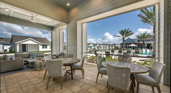 a view of a dining room with furniture a chandelier and wooden floor