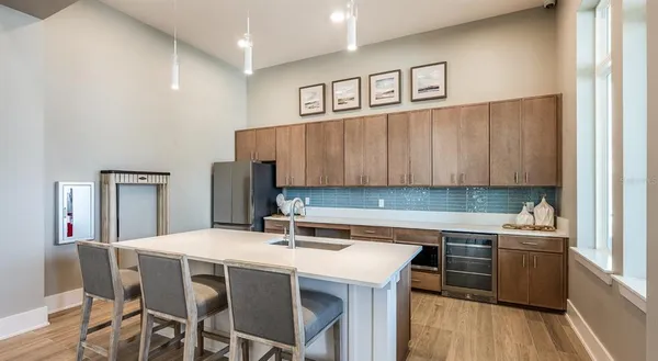 a kitchen with a dining table chairs and cabinets