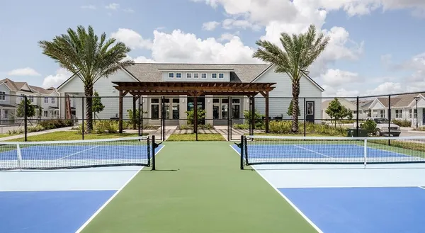 a view of an house with swimming pool and chairs