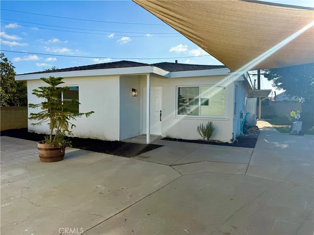 an entrance to house with potted plants