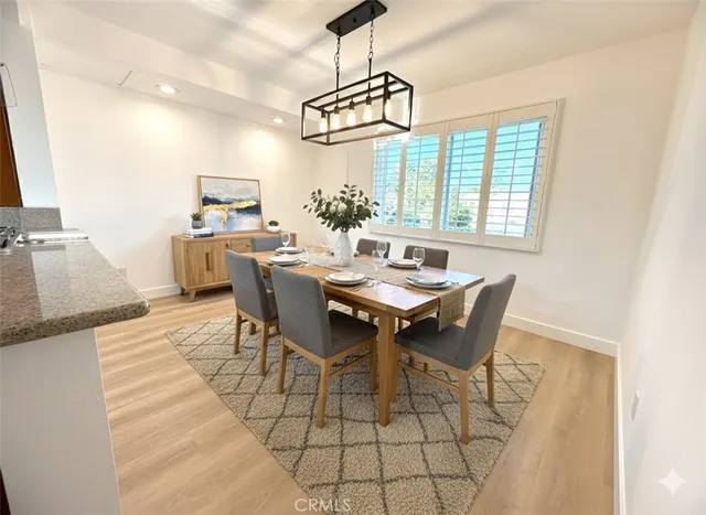a dining room with furniture a chandelier and wooden floor
